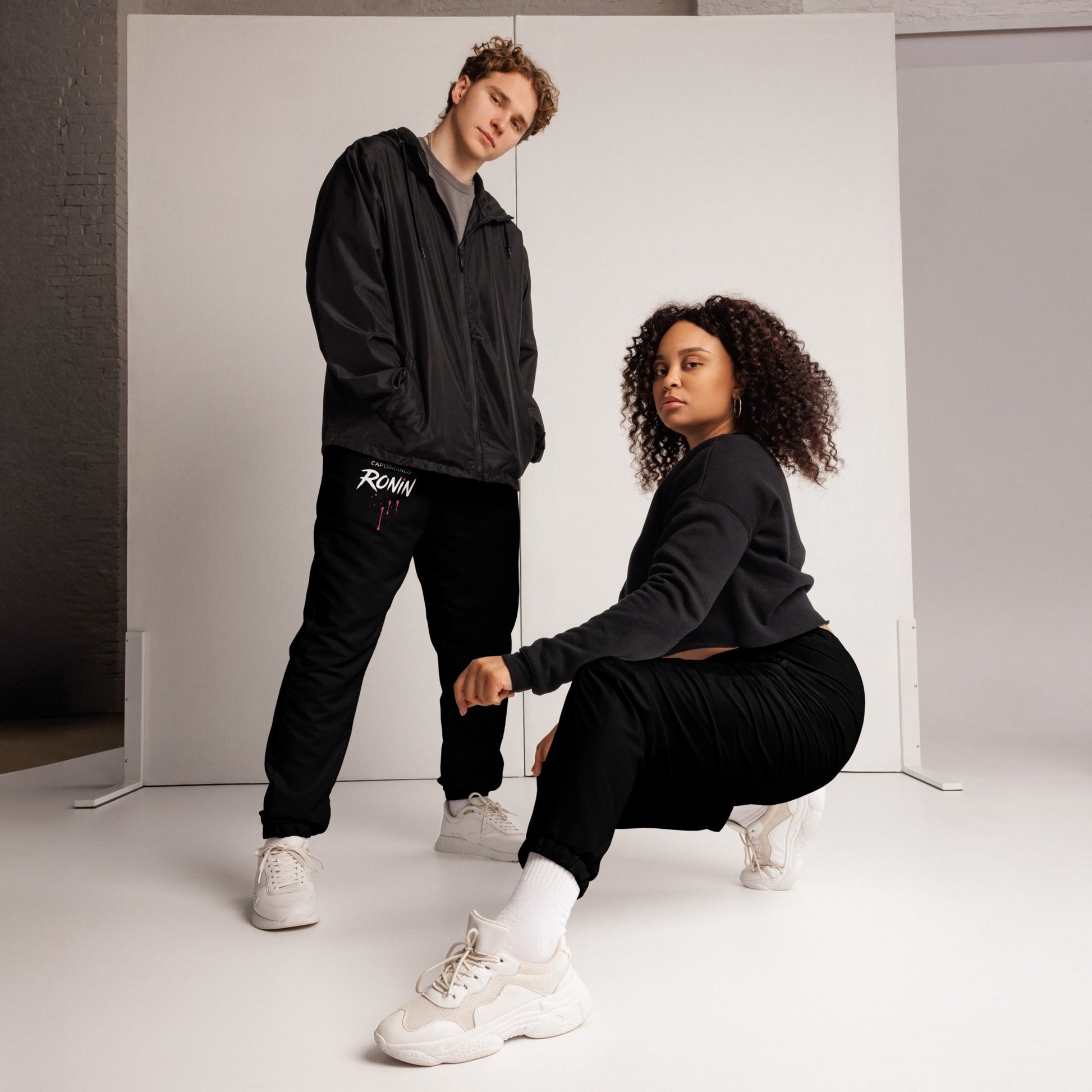 Two models wearing Capobranco Ronin joggers – unisex urban fashion in relaxed fit for everyday street style.