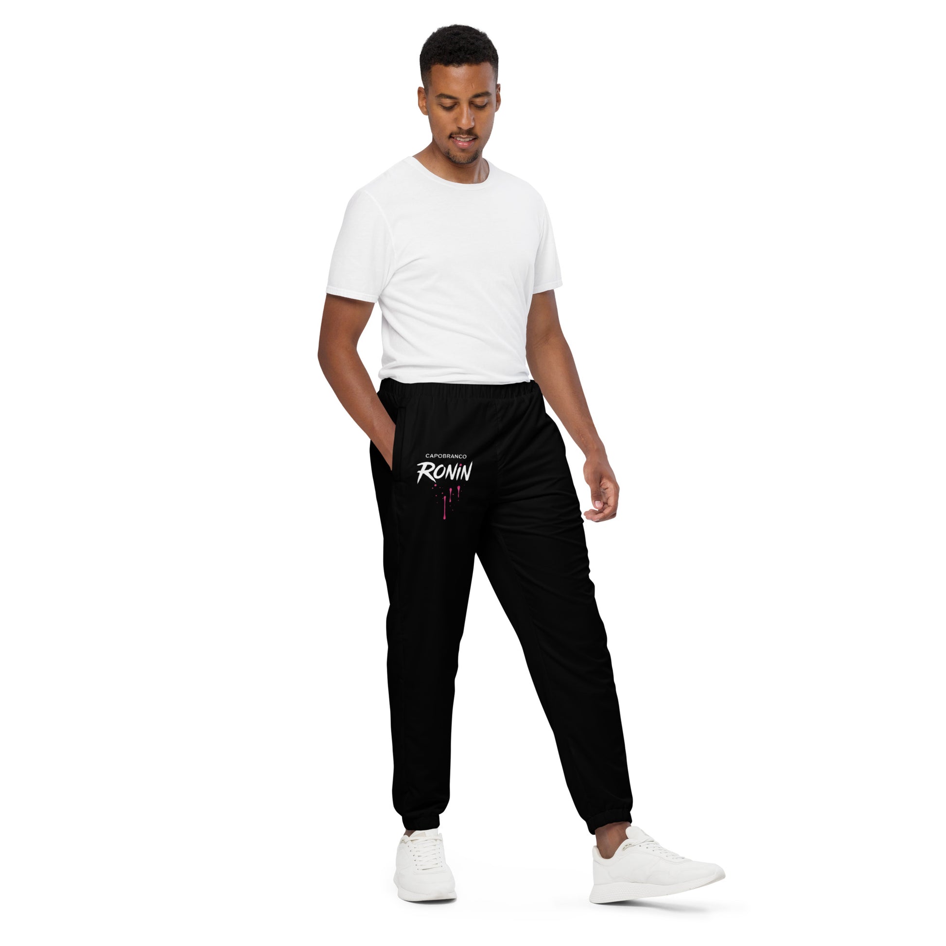 Full-body shot of male model in Capobranco Ronin Neon joggers – minimalist design with bold branding.